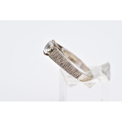 109 - A WHITE METAL SINGLE STONE RING, designed with a claw set, circular cut, colourless stone assessed a... 