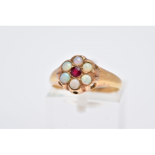 110 - A YELLOW METAL OPAL AND GARNET CLUSTER RING, designed with a central circular cut garnet, within a s... 