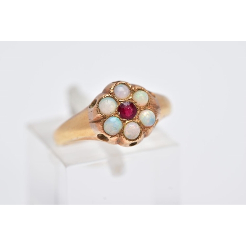 110 - A YELLOW METAL OPAL AND GARNET CLUSTER RING, designed with a central circular cut garnet, within a s... 