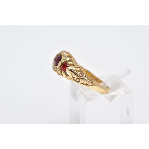 113 - AN 18CT GOLD GARNET AND DIAMOND GYPSY RING, designed with a central oval cut garnet, flanked with ci... 