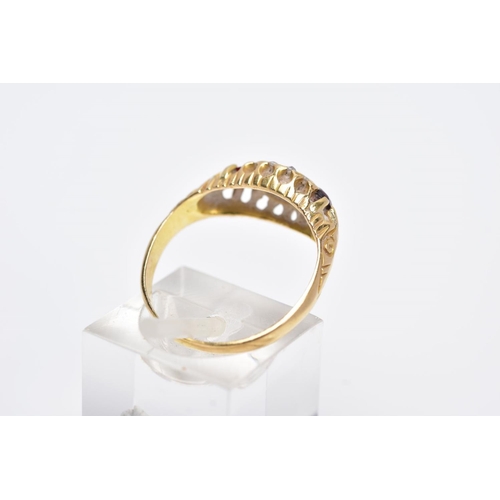 113 - AN 18CT GOLD GARNET AND DIAMOND GYPSY RING, designed with a central oval cut garnet, flanked with ci... 