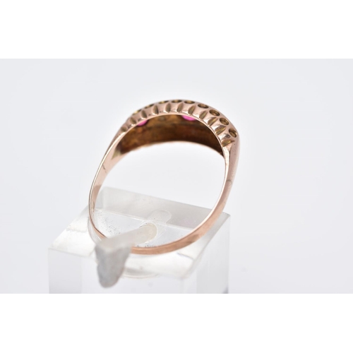 114 - A 9CT GOLD RUBY AND DIAMOND BOAT RING, designed with a row of circular cut rubies interspaced with r... 