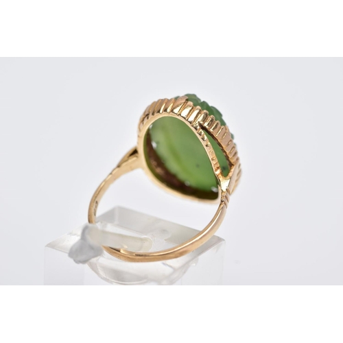 13 - A 9CT GOLD, CARVED NEPHRITE CAMEO RING, of an oval form with a carved floral design, beaded surround... 