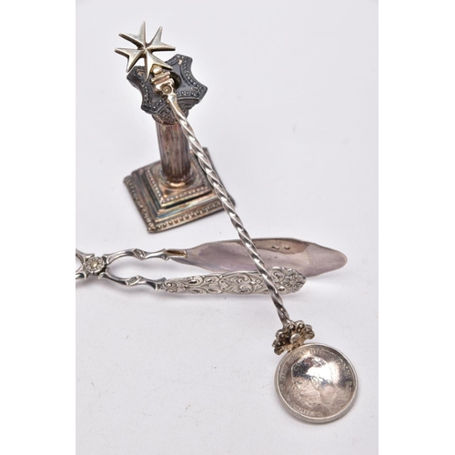 67 - A SILVER CANDLESTICK, A PAIR OF TONGS AND A SPOON, a single column, dwarf candlestick, on a stepped ... 