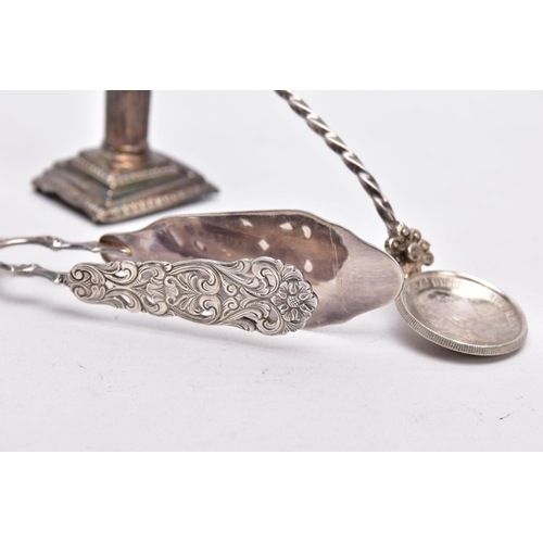 67 - A SILVER CANDLESTICK, A PAIR OF TONGS AND A SPOON, a single column, dwarf candlestick, on a stepped ... 