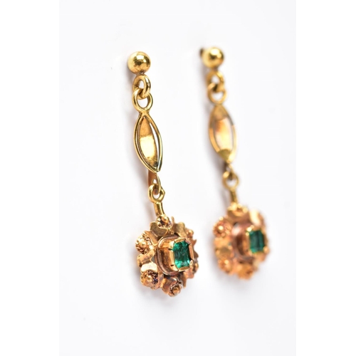 68 - A PAIR OF YELLOW METAL, EMERALD SET DROP EARRINGS, each suspending an emerald cut emerald within a d... 