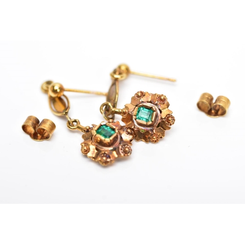 68 - A PAIR OF YELLOW METAL, EMERALD SET DROP EARRINGS, each suspending an emerald cut emerald within a d... 