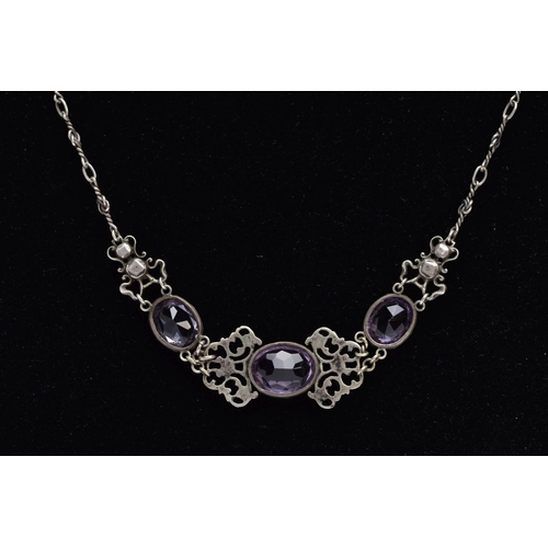 69 - AN ARTS AND CRAFTS AMETHYST NECKLACE, designed with three collet set, oval mix cut amethysts, inters... 