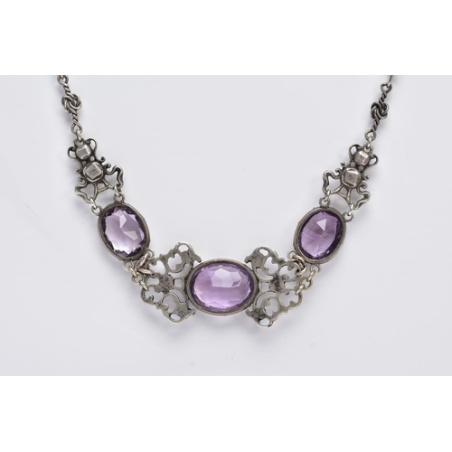 69 - AN ARTS AND CRAFTS AMETHYST NECKLACE, designed with three collet set, oval mix cut amethysts, inters... 