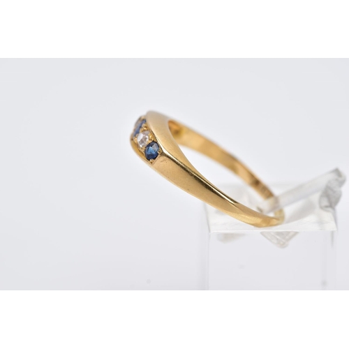 73 - AN 18CT GOLD FIVE STONE RING, of a boat shape, set with a central oval cut blue sapphire interspaced... 