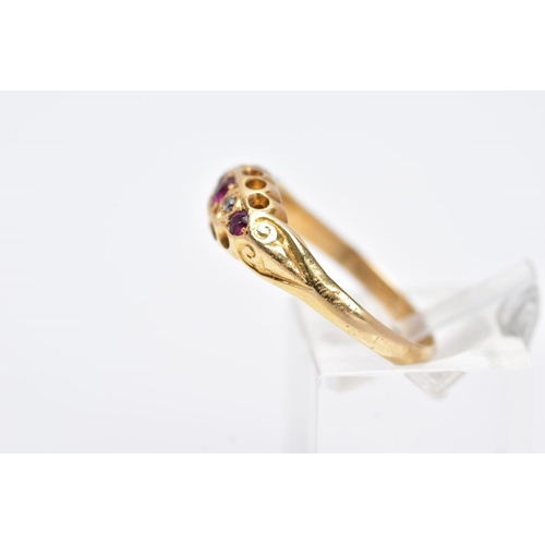 74 - AN EARLY 20TH CENTURY DIAMOND AND RUBY RING, of a boat shape, set with three circular cut rubies, in... 