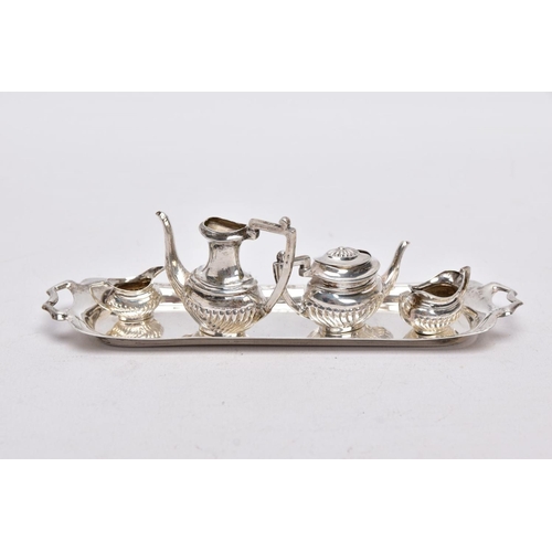 82 - A MINIATURE FIVE PIECE SILVER TEA SET, comprising of teapot with cover, coffee pot missing cover, a ... 