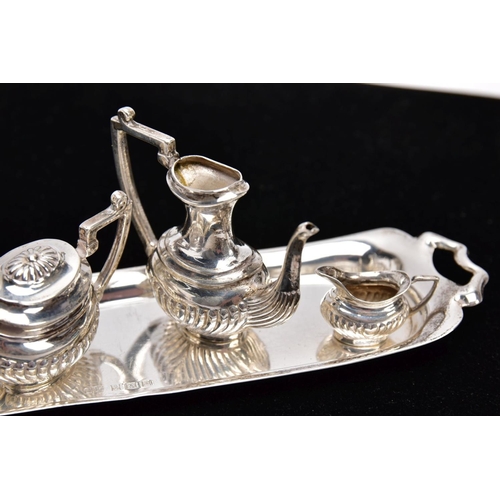 82 - A MINIATURE FIVE PIECE SILVER TEA SET, comprising of teapot with cover, coffee pot missing cover, a ... 