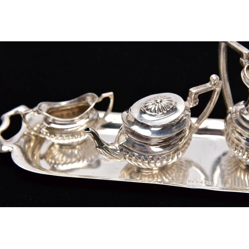 82 - A MINIATURE FIVE PIECE SILVER TEA SET, comprising of teapot with cover, coffee pot missing cover, a ... 