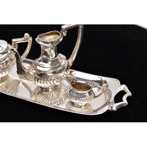 82 - A MINIATURE FIVE PIECE SILVER TEA SET, comprising of teapot with cover, coffee pot missing cover, a ... 