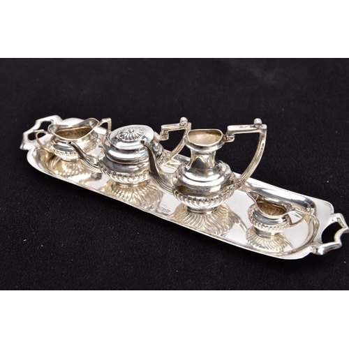 82 - A MINIATURE FIVE PIECE SILVER TEA SET, comprising of teapot with cover, coffee pot missing cover, a ... 