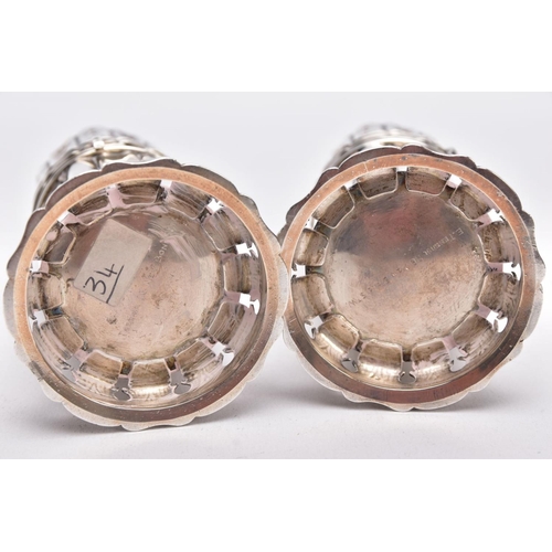 86 - TWO GEORGE V SILVER SUGAR CASTERS, column form, wavy openwork base, pierced cover with a ball finial... 