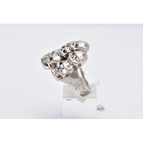 75 - A GENTS SILVER SKULL RING, large ring designed with seven openwork skulls, stamped '925' Birmingham,... 