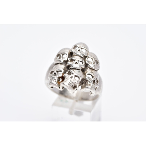 75 - A GENTS SILVER SKULL RING, large ring designed with seven openwork skulls, stamped '925' Birmingham,... 
