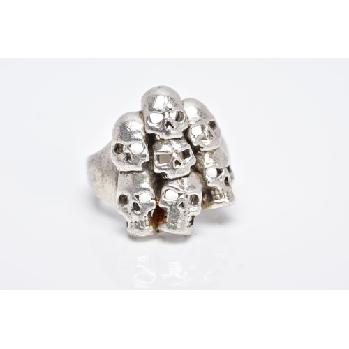 75 - A GENTS SILVER SKULL RING, large ring designed with seven openwork skulls, stamped '925' Birmingham,... 