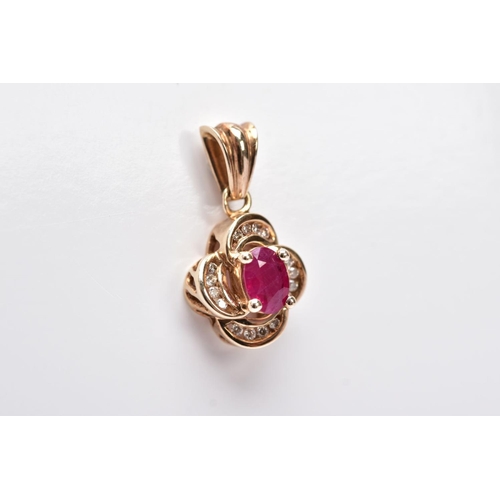 11 - A 9CT GOLD RUBY AND DIAMOND PENDANT, centring on an oval cut ruby (possibly treated/synthetic), with... 