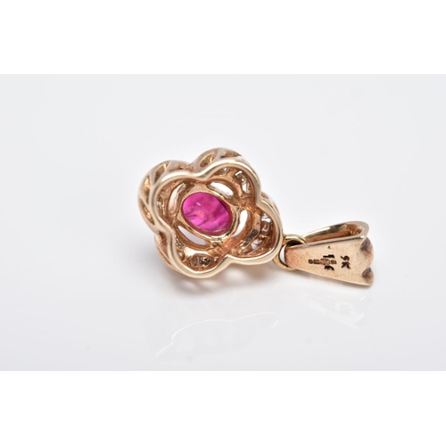 11 - A 9CT GOLD RUBY AND DIAMOND PENDANT, centring on an oval cut ruby (possibly treated/synthetic), with... 