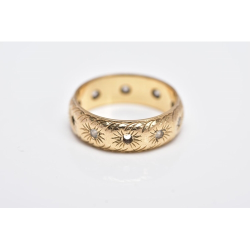 122 - A 9CT GOLD GEM SET BAND, textured engraved design set with circular cut colourless stones assessed a... 