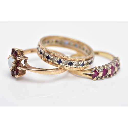 123 - THREE 9CT GOLD GEM SET RINGS, to include a full eternity ring set with colourless spinel and blue sa... 