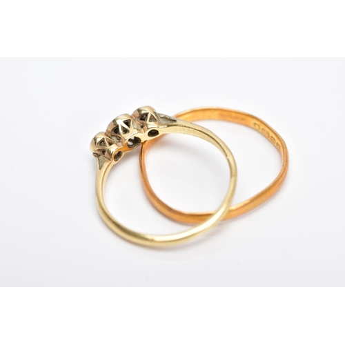 124 - A YELLLOW METAL THREE STONE DIAMOND RING AND A 22CT GOLD BAND, the diamond ring centring on an illus... 