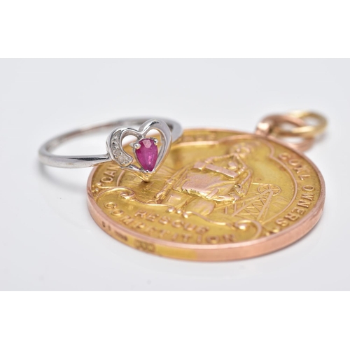 134 - A 9CT GOLD MOUNTED MEDAL AND A 9CT WHITE GOLD RUBY AND DIAMOND RING, the medal of a circular form, i... 