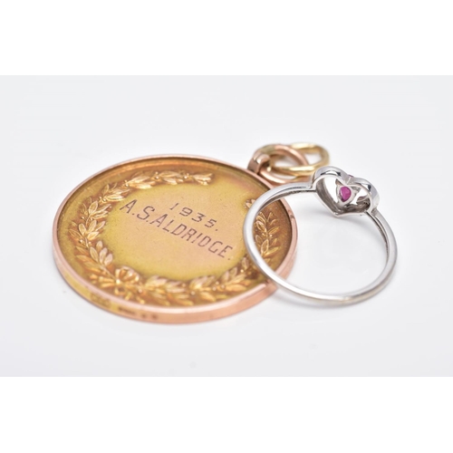 134 - A 9CT GOLD MOUNTED MEDAL AND A 9CT WHITE GOLD RUBY AND DIAMOND RING, the medal of a circular form, i... 