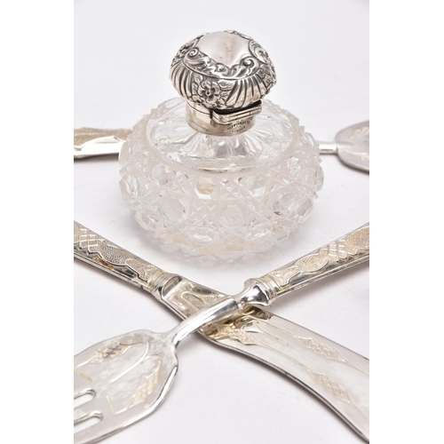 142 - A SILVER MOUNTED CUT GLASS JAR, SILVER NAPKIN, SILVER HANDLED TRIDENT FORK AND A THREE PIECE WHITE M... 