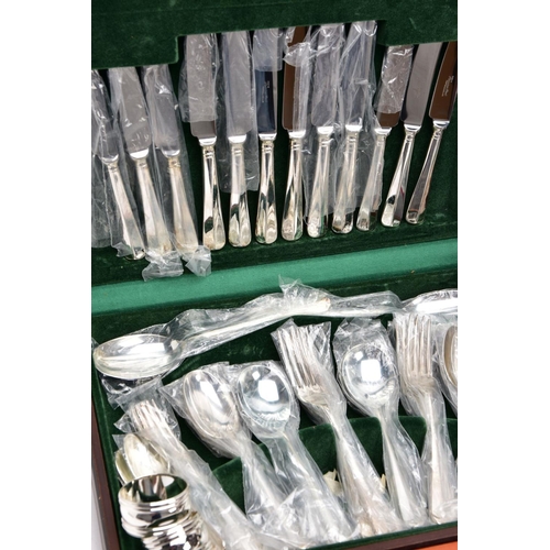 146 - A COMPLETE CANTEEN OF CUTLERY, TWO GOBLETS, SIX NAPKIN RINGS AND A THREE PIECE CUTLERY SET, the wood... 