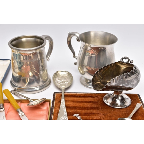 147 - A BOX OF WHITE METAL WARE, to include a pewter hammer effect tankard, with a scroll handle, a bell s... 