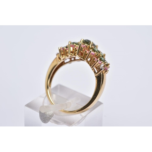 153 - A 9CT GOLD GEM SET HALF HOOP RING, designed with five oval cut graduated green stones assessed as sa... 