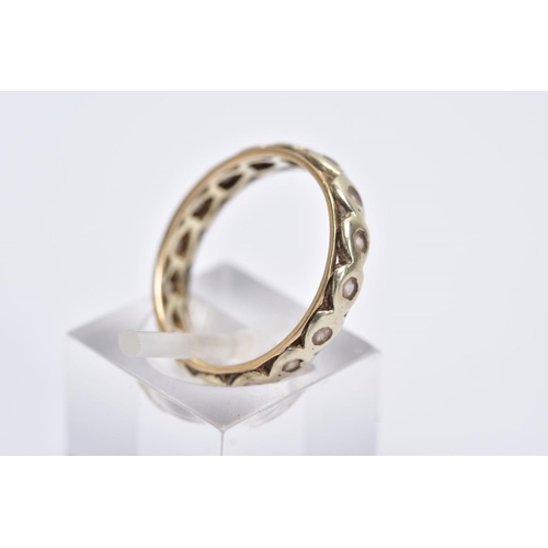 161 - A 9CT GOLD FULL ETERNITY RING, set with colourless stones assessed as spinel, each within a heart sh... 