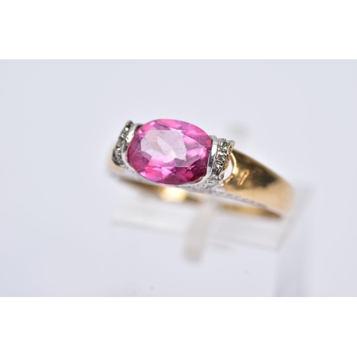 162 - A 9CT GOLD PINK TOPAZ RING, designed with a tension set, oval cut pink topaz, single cut diamond det... 