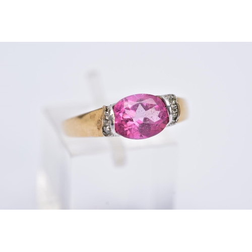 162 - A 9CT GOLD PINK TOPAZ RING, designed with a tension set, oval cut pink topaz, single cut diamond det... 