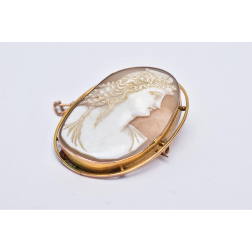 168 - A GOLD CAMEO BROOCH, depicting a maiden in profile, measuring approximately 42mm x 33mm, stamped '9c... 