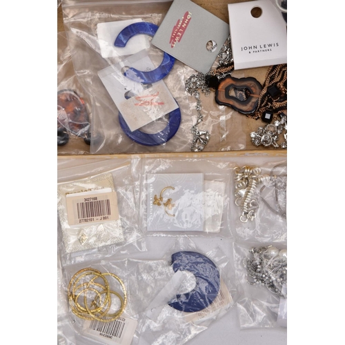 189 - A TRAY OF COSTUME JEWELLERY, some pieces with tags and packaging, to include a large resin hoop neck... 