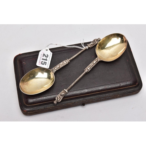 215 - A CASED TWO PIECE LATE VICTORIAN SILVER GILT SPOON SET, brown case opens to reveal a purple velvet a... 