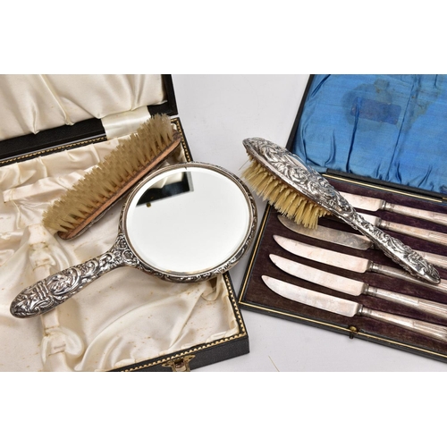 224 - A CASED THREE PIECE SILVER VANITY SET AND A CASED SILVER HANDLED KNIFE SET, the black vanity case op... 