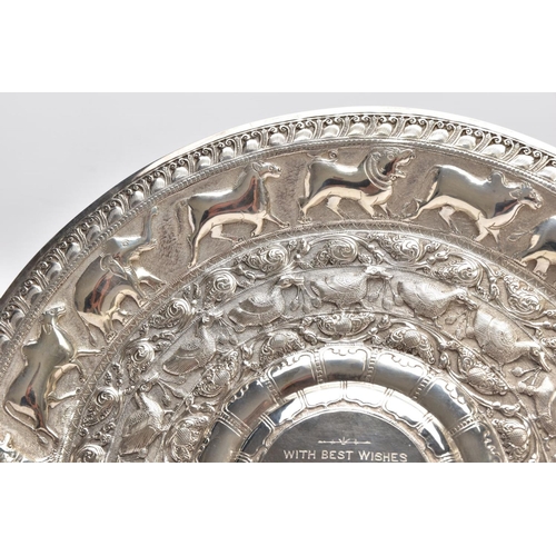 232 - AN INDIAN WHITE METAL PRESENTATION SALVER, embossed animal and foliate design, engraved to the centr... 