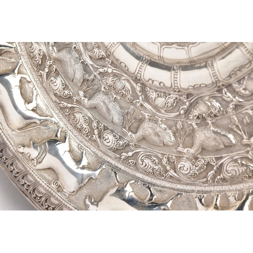 232 - AN INDIAN WHITE METAL PRESENTATION SALVER, embossed animal and foliate design, engraved to the centr... 