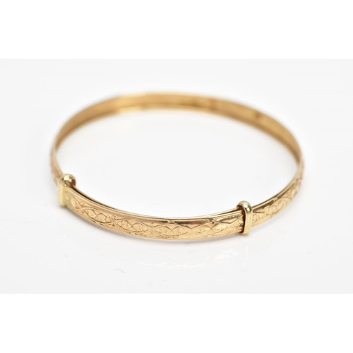 251 - A 9CT GOLD CHRISTENING BANGLE, embossed heart and scroll design, hallmarked 9ct gold Birmingham, app... 