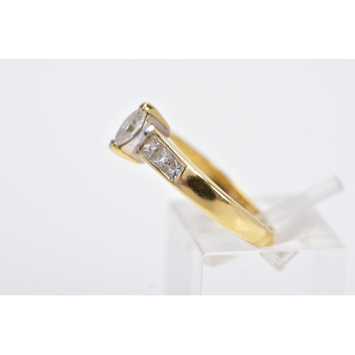 27 - A YELLOW METAL DIAMOND RING, designed with a central raised, marquise cut diamond, flanked with prin... 