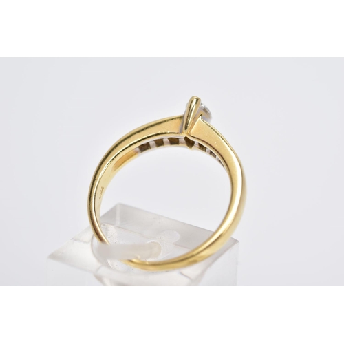 27 - A YELLOW METAL DIAMOND RING, designed with a central raised, marquise cut diamond, flanked with prin... 