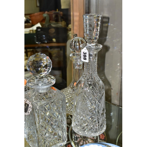 388 - FOUR CUT GLASS DECANTERS, comprising a Waterford ships decanter and stopper and a Waterford mallet s... 