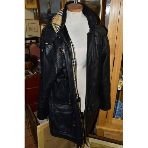 563 - A BURBERRY BLACK LEATHER DUFFLE COAT, labelled as '42', with Burberry check lining and with hood att... 