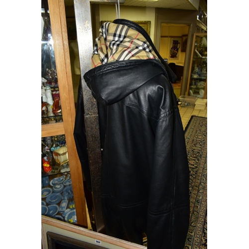 563 - A BURBERRY BLACK LEATHER DUFFLE COAT, labelled as '42', with Burberry check lining and with hood att... 